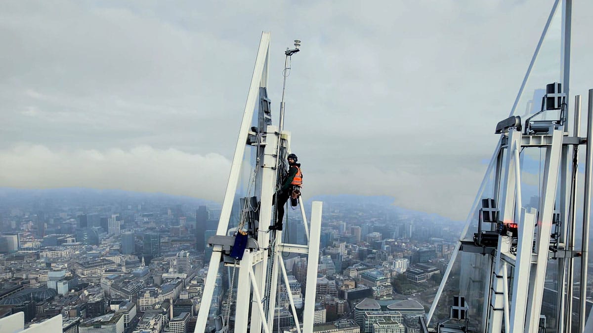 Rope access technician working high above the London skyline